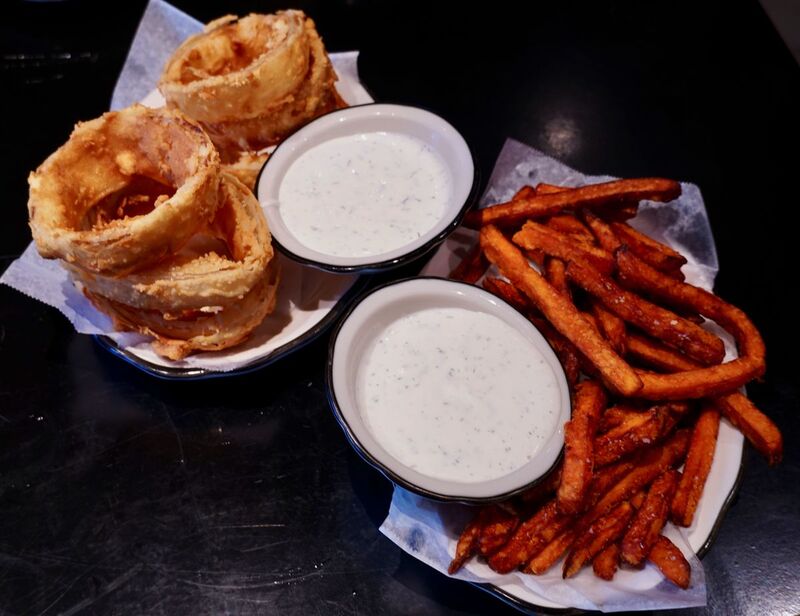 Sweet potato fries and onion rings at Black Tap. Photo by The Foodie Biz